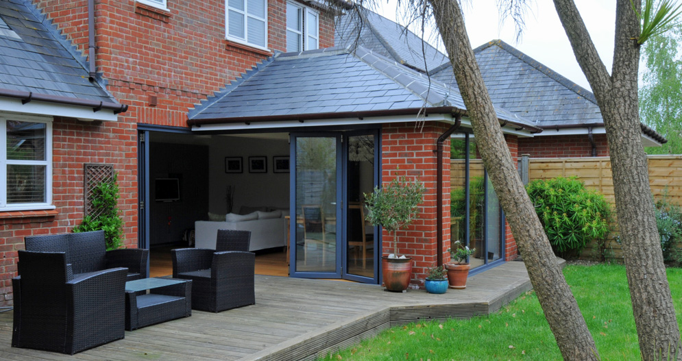 Bespoke floating corner post bi folding door system to provide an unobscured view when the doors are open.